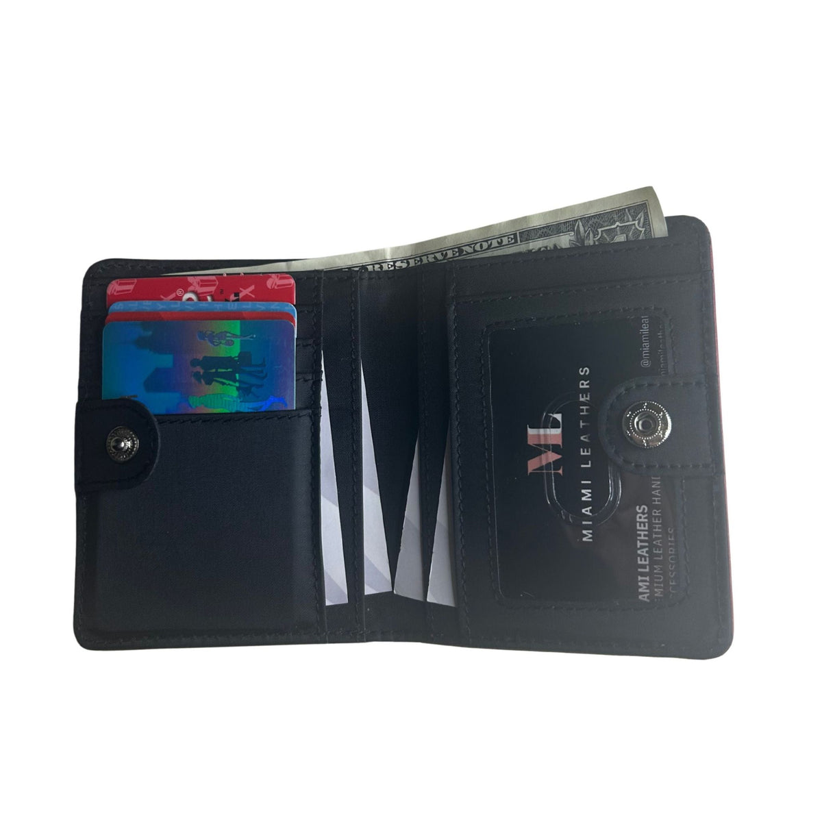A black lambskin leather bifold wallet shown open, displaying card slots with sample cards, a cash compartment, and an ID window. The wallet features a snap-button closure.