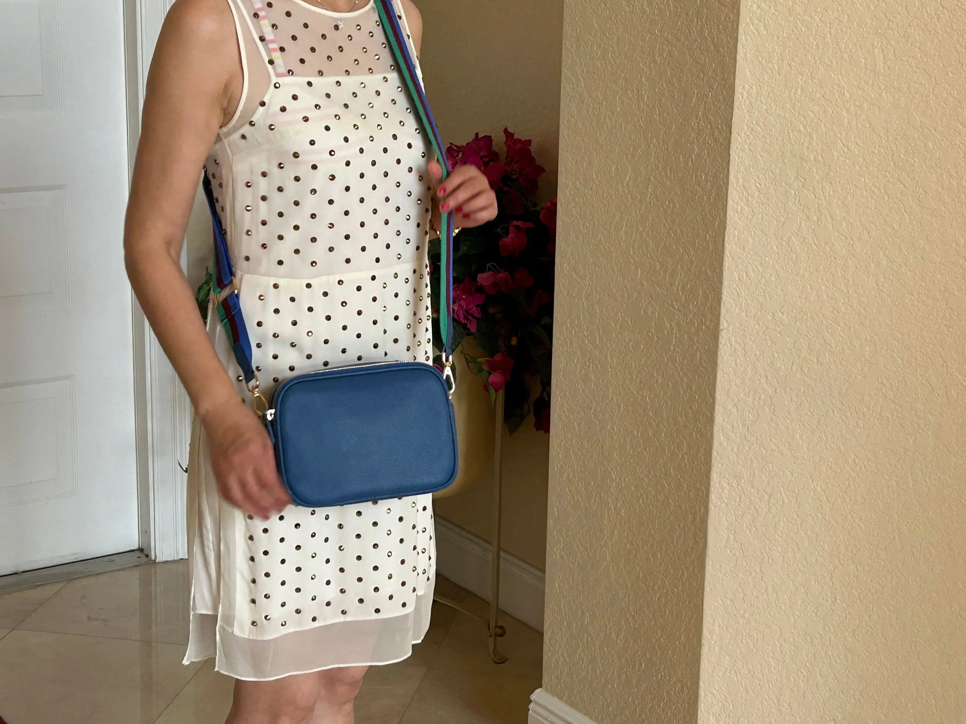 Woman carrying blue Sophia leather crossbody bag for everyday use