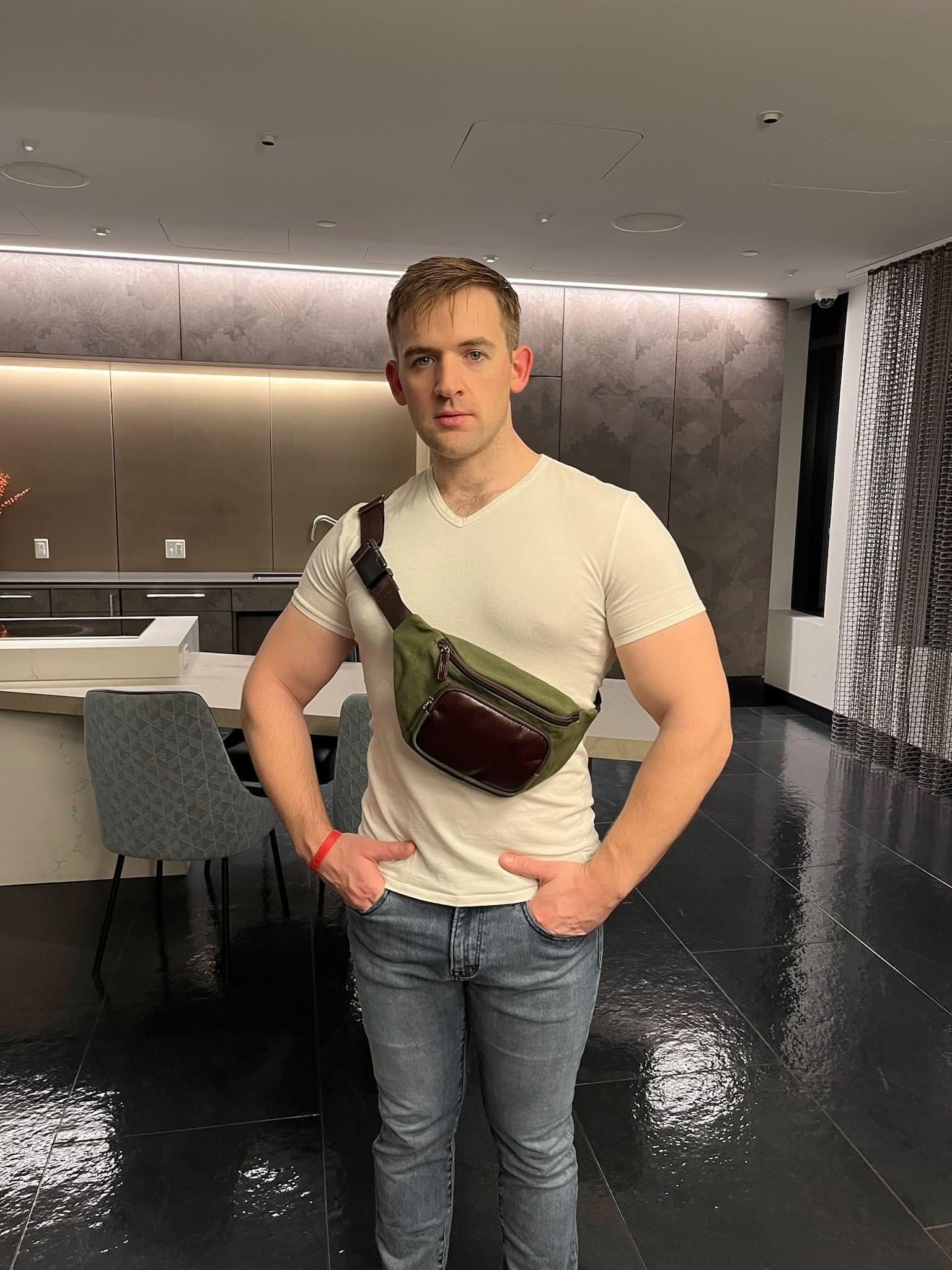 Man wearing waxed canvas waist pack across the chest for hands-free carry