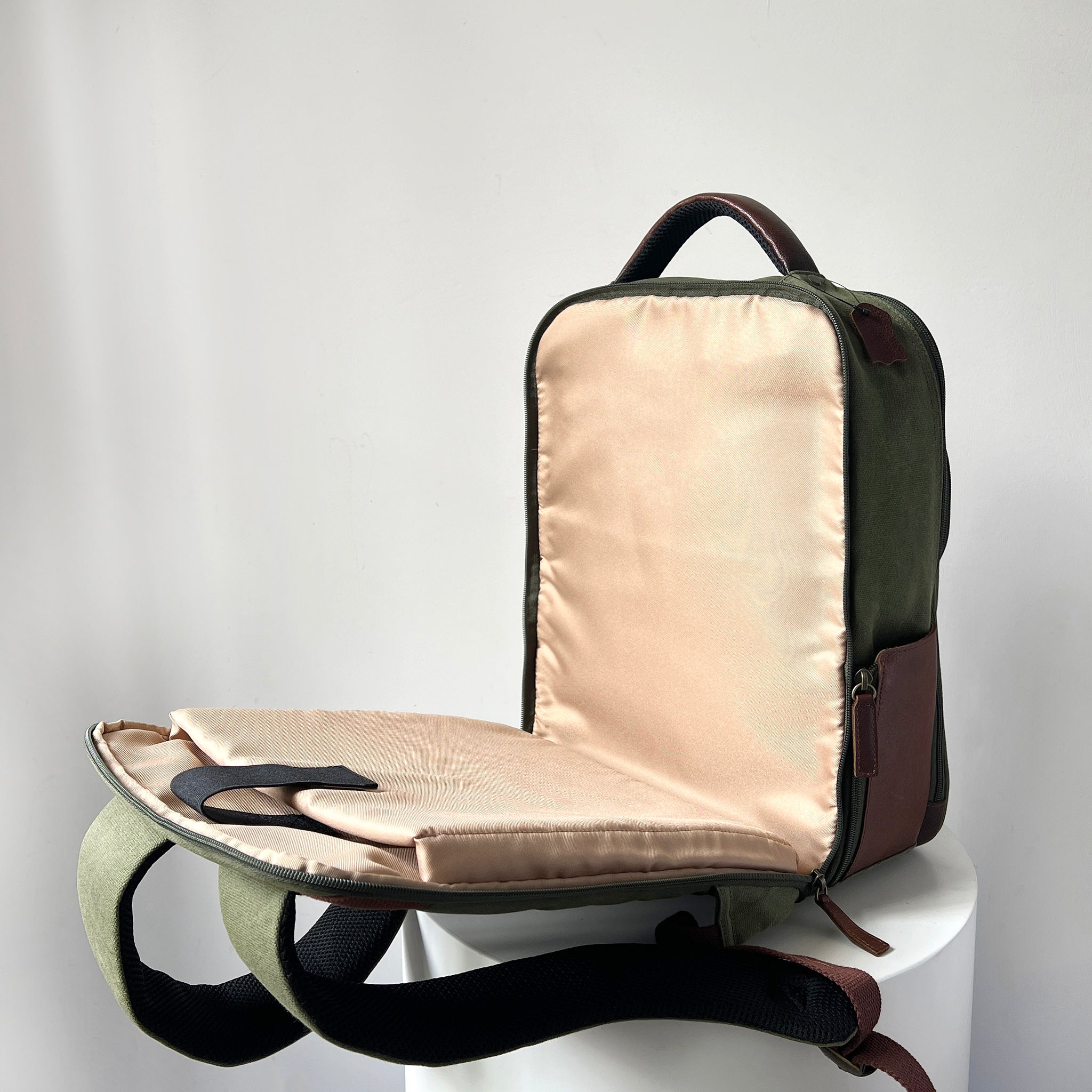 Maxwell waxed canvas backpack open on chair for work and travel