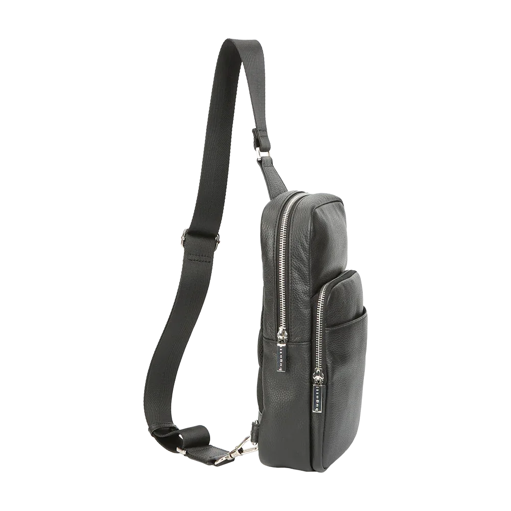 Side view of black leather sling bag with adjustable strap