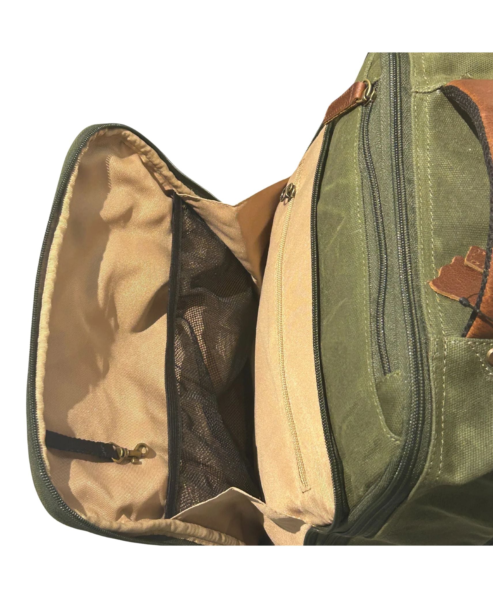 waxed green canvas bag with tan interior lining, zipper compartments, and brown leather trim