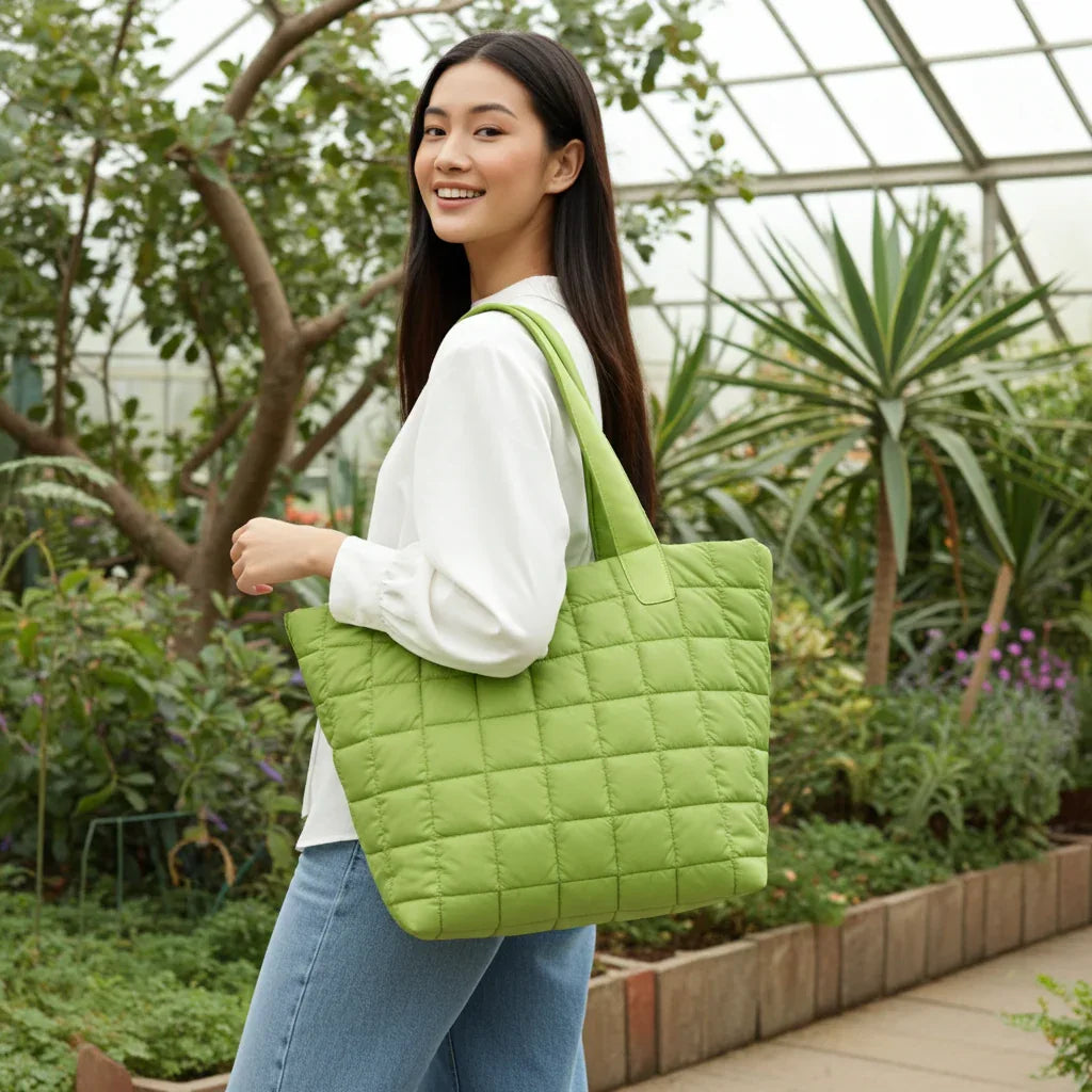 Woman carrying green quilted nylon tote bag as a shoulder bag