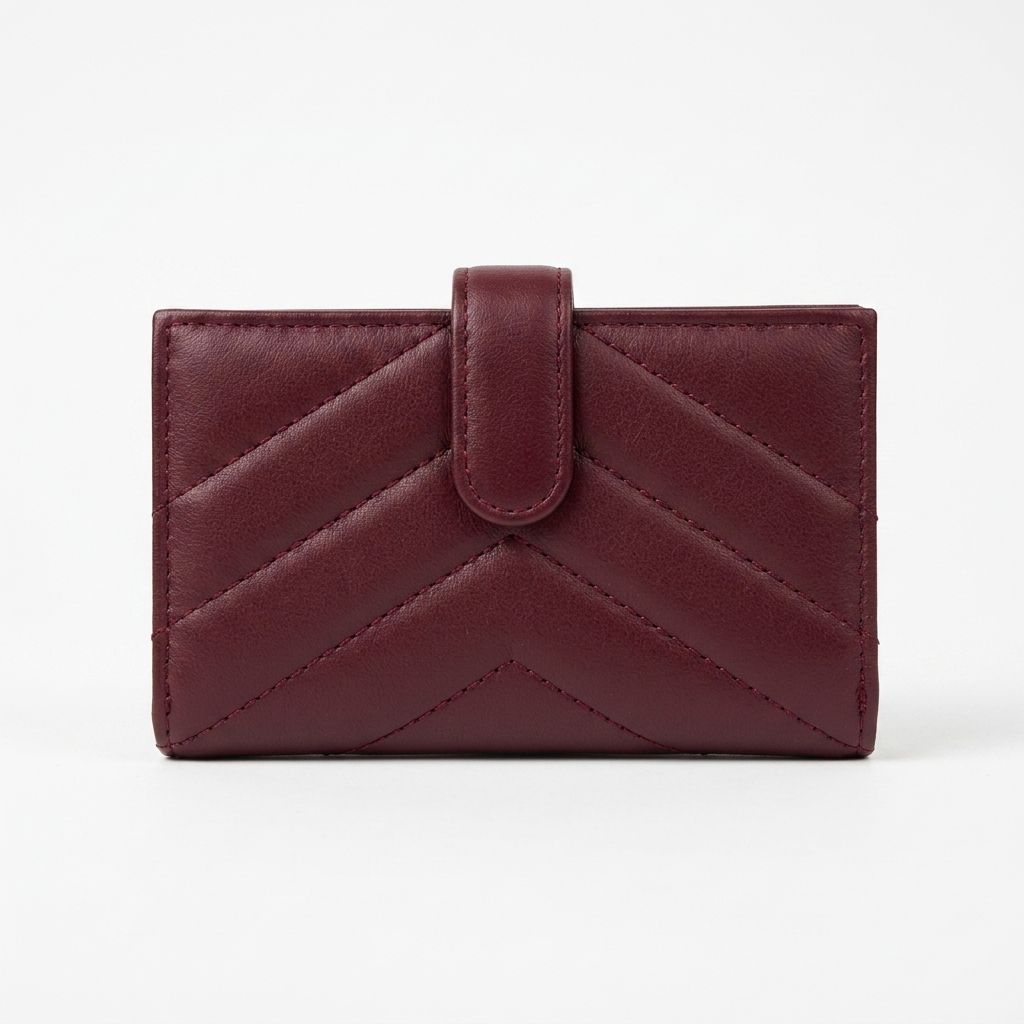 A burgundy lambskin leather wallet with a chevron quilted pattern and a central tab closure