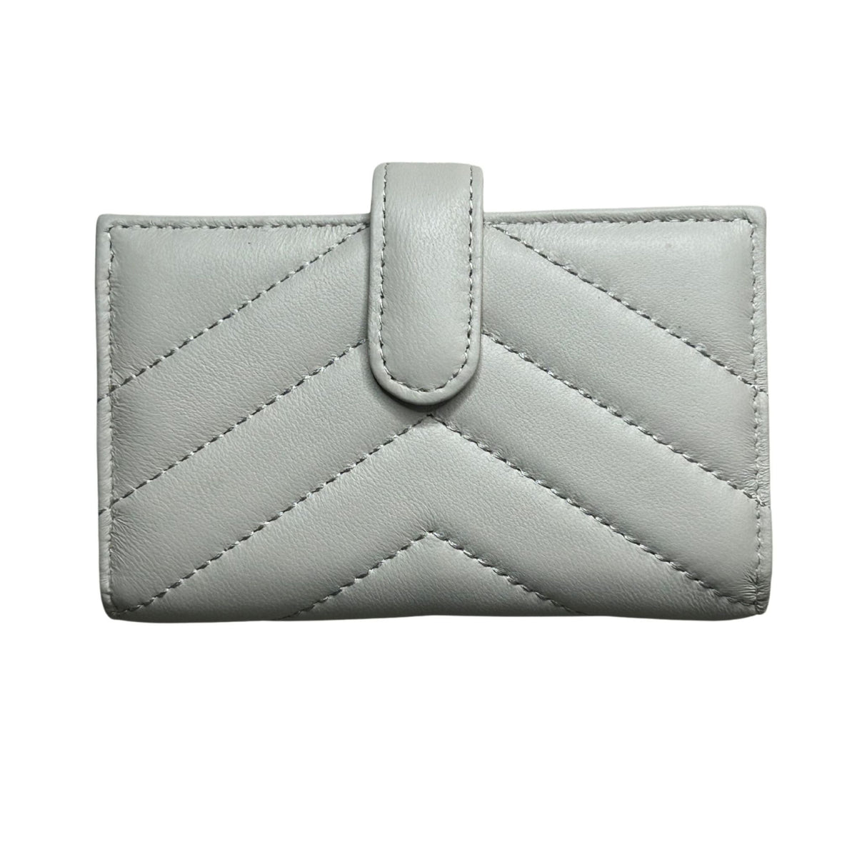 A white/ivory quilted lambskin leather wallet with a chevron pattern and a central tab closure