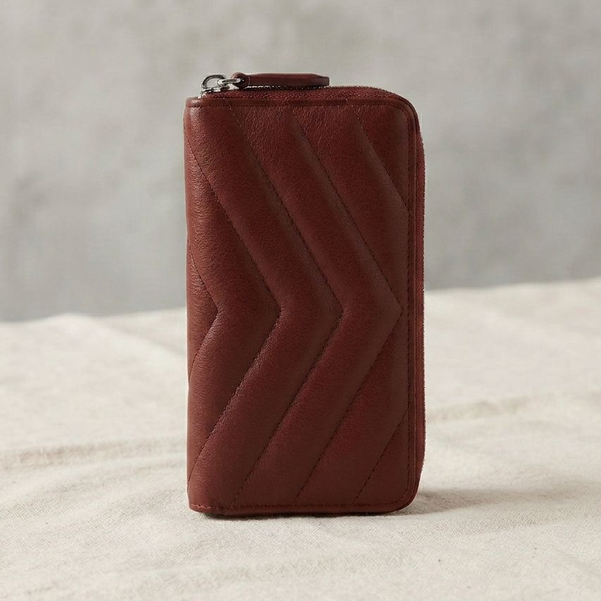 A burgendy lampskin leather zip-around wallet