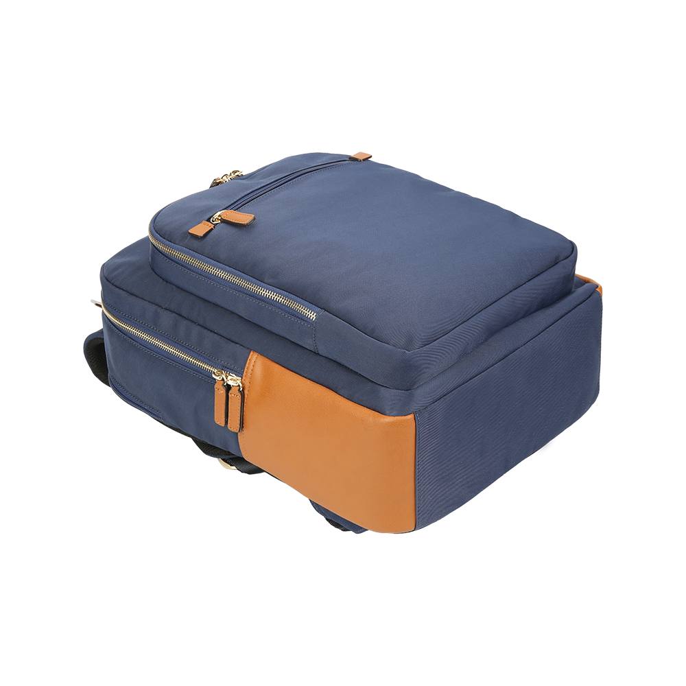 Detail of front zip pocket and brown leather trim on nylon backpack