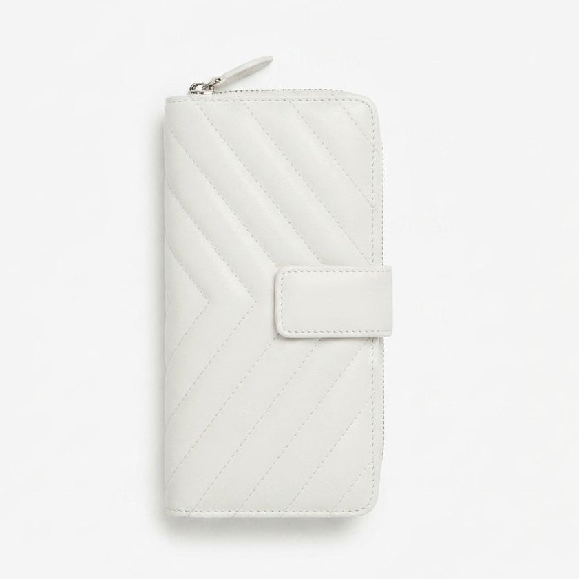 A white New Zealand lambskin leather zip-around wallet with a chevron quilted pattern and a snap-button 