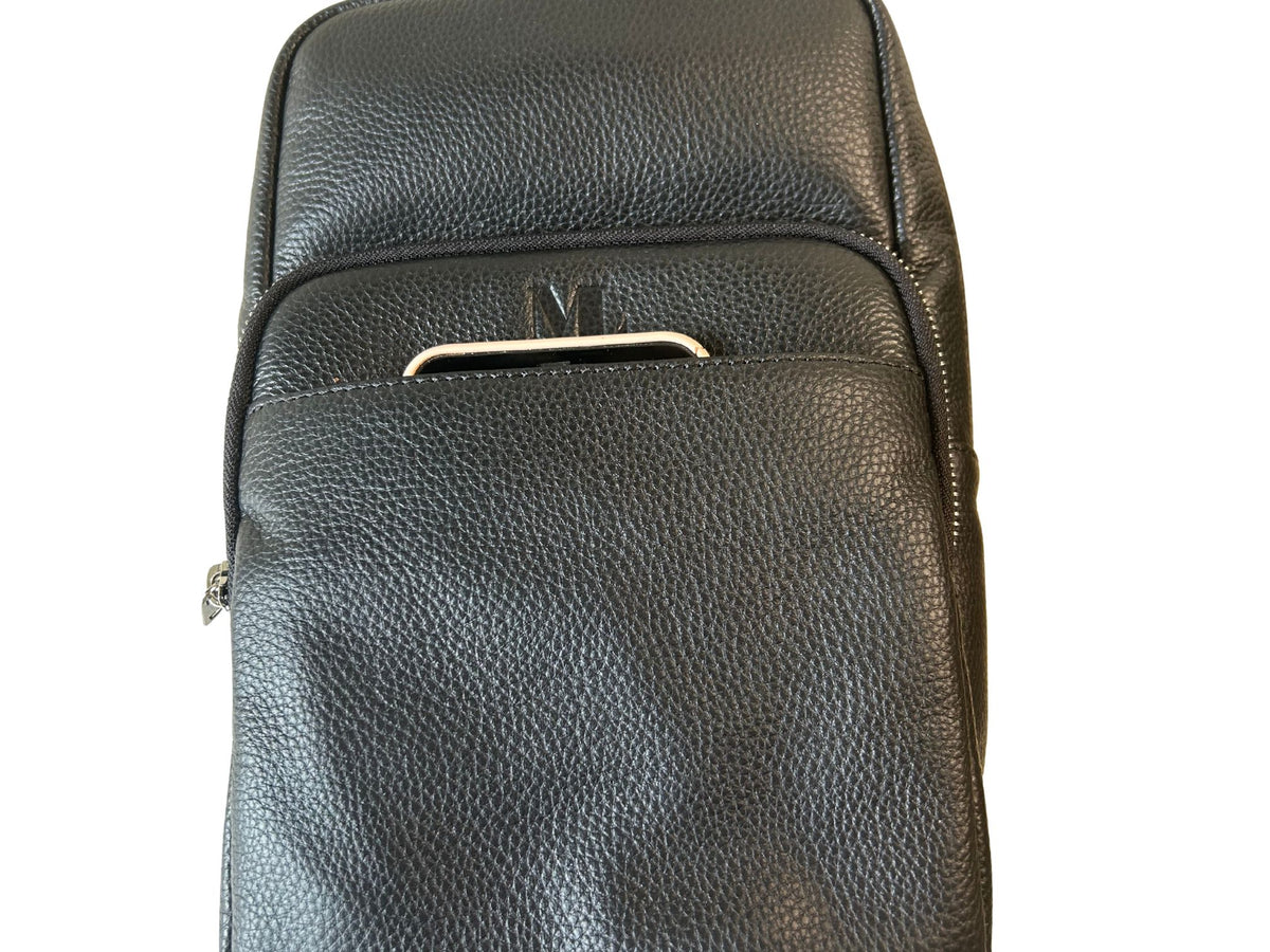 Black leather sling bag front quick-access pocket shown with iPhone Pro