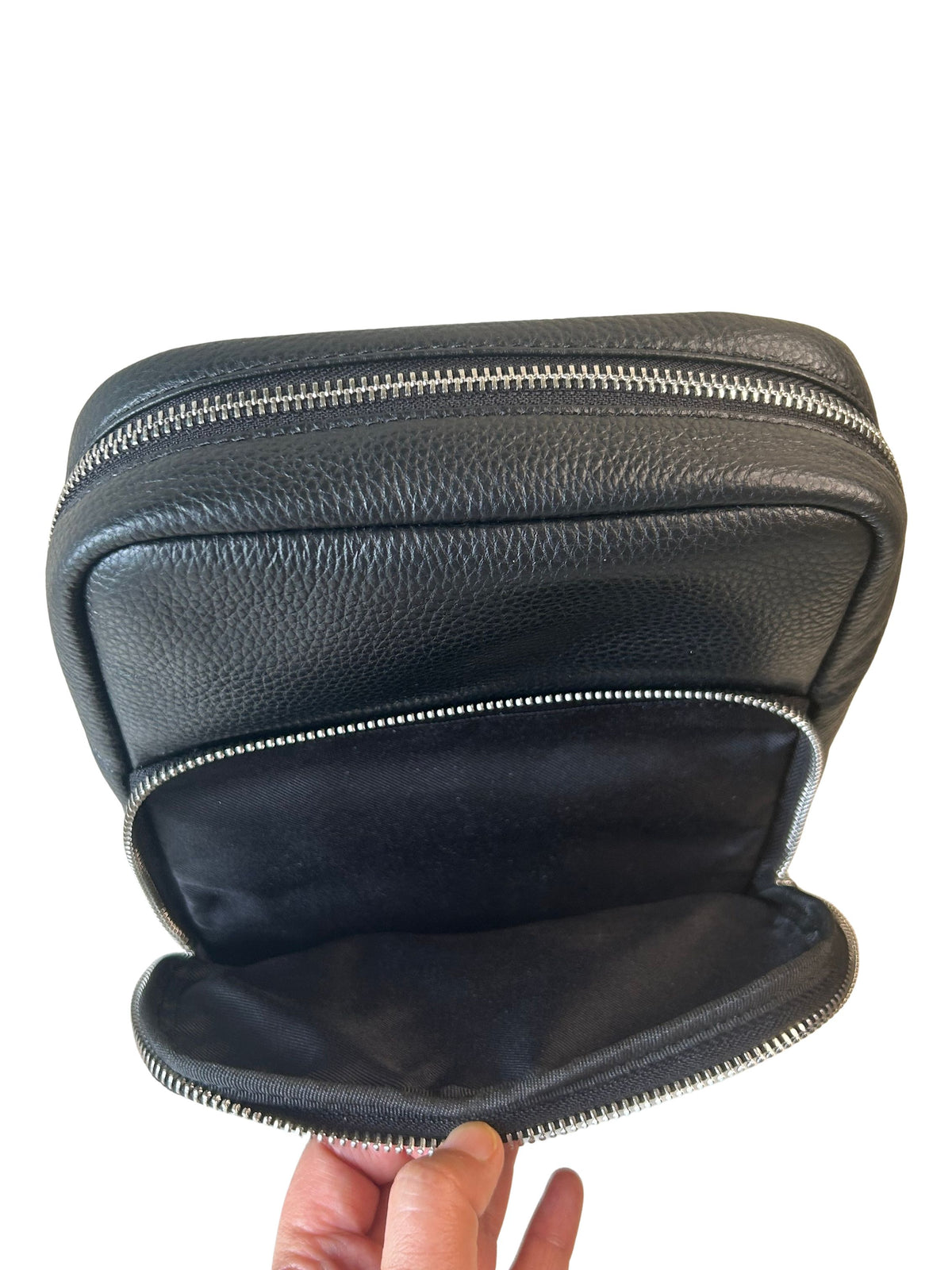 Black pebbled leather sling bag second zip-around storage compartment