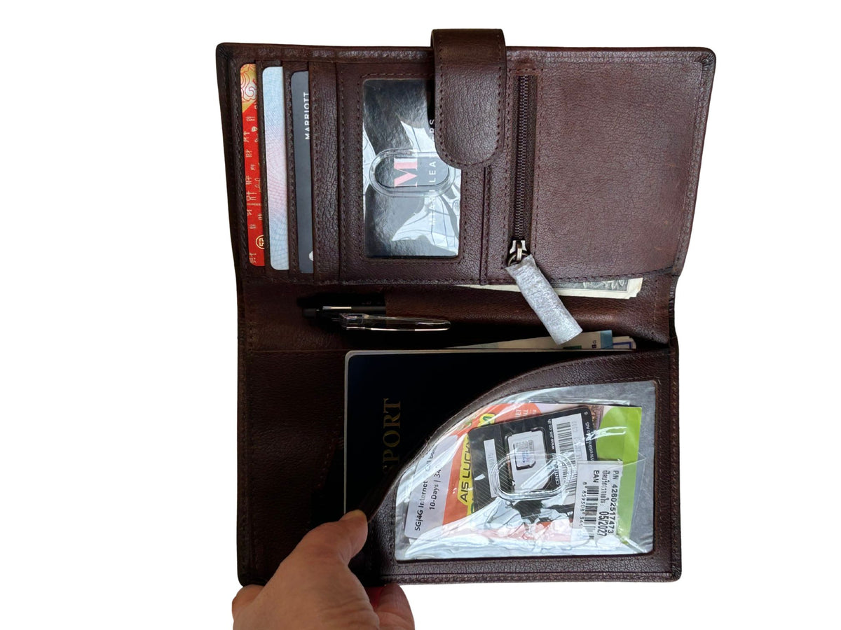 Cambridge leather travel wallet open with passport, card slots, ID window, zip pocket and travel document storage