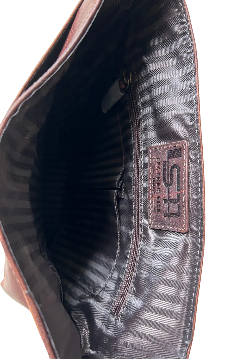 Interior side view of compact leather messenger bag with patterned lining
