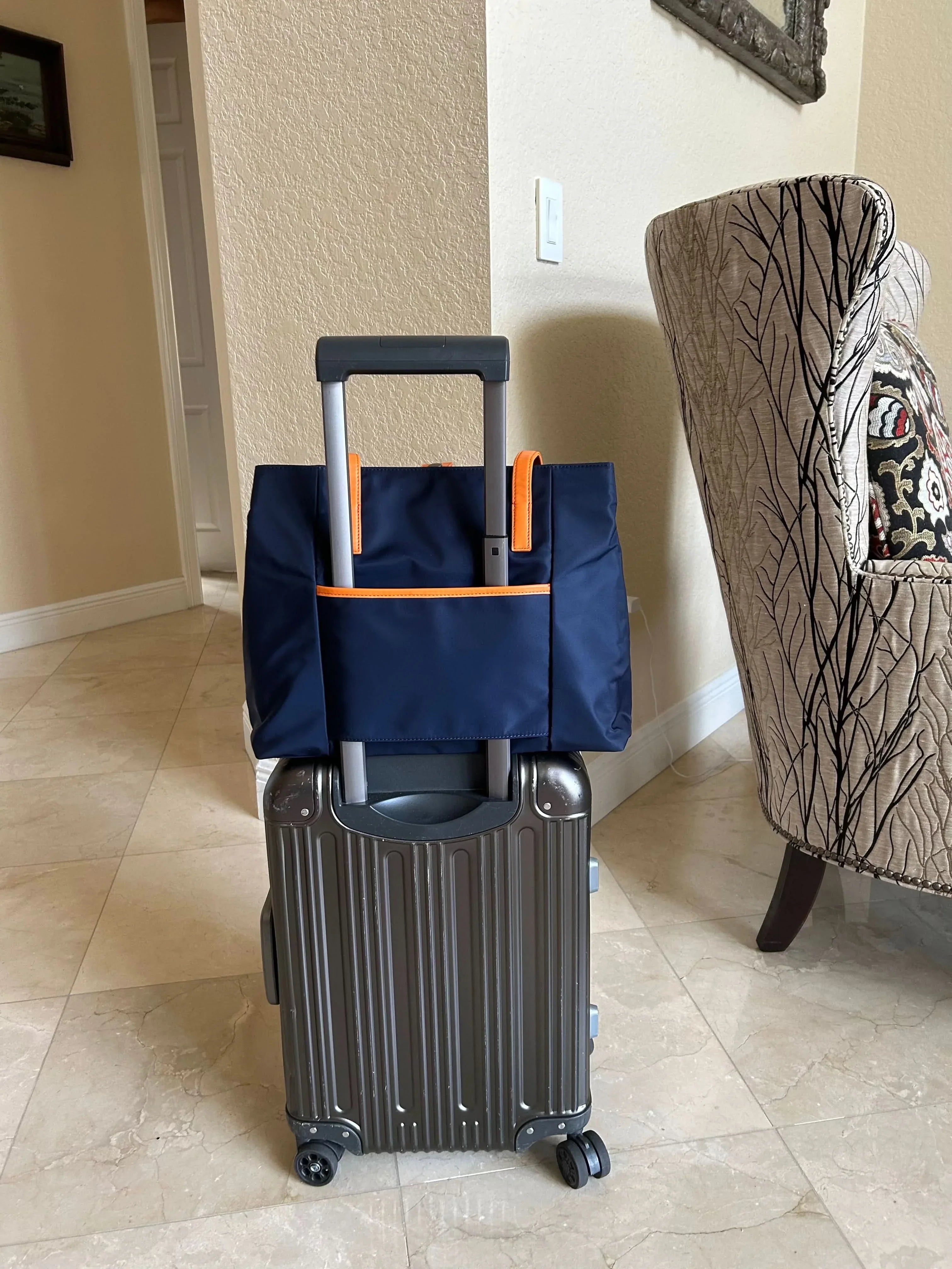 Lightweight business travel tote bag with trolley strap on rolling luggage