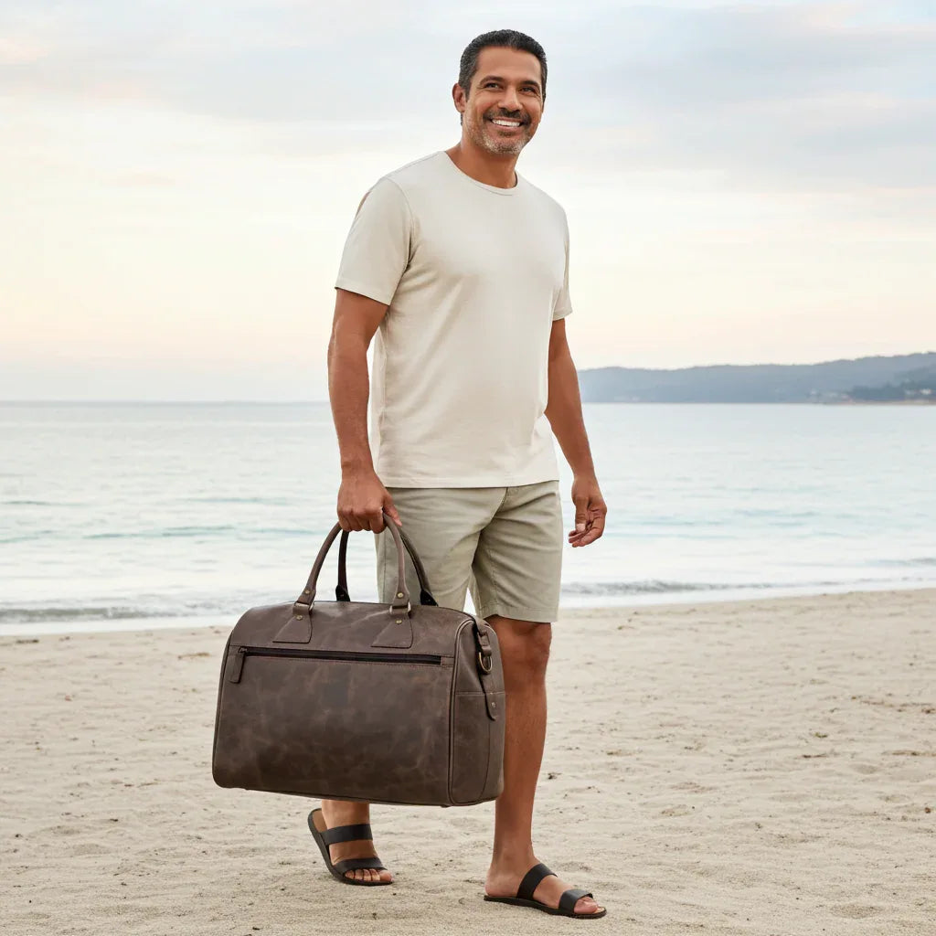 Man carrying Crazy Horse leather weekender bag for beach travel