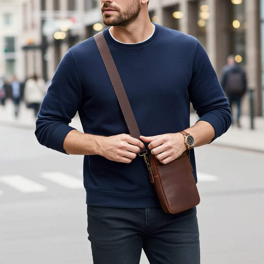 Man wearing full-grain leather phone pouch as a crossbody bag
