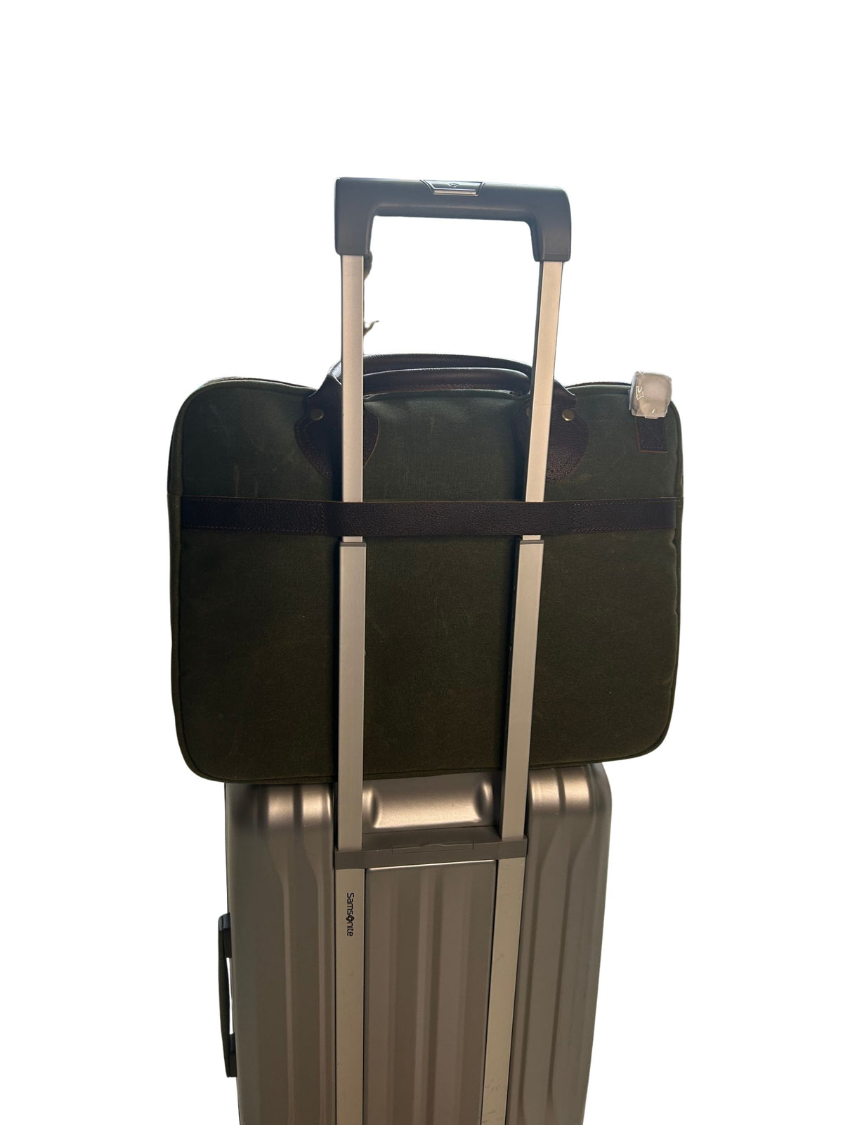Maxwell waxed canvas messenger bag trolley sleeve secured over rolling luggage handle