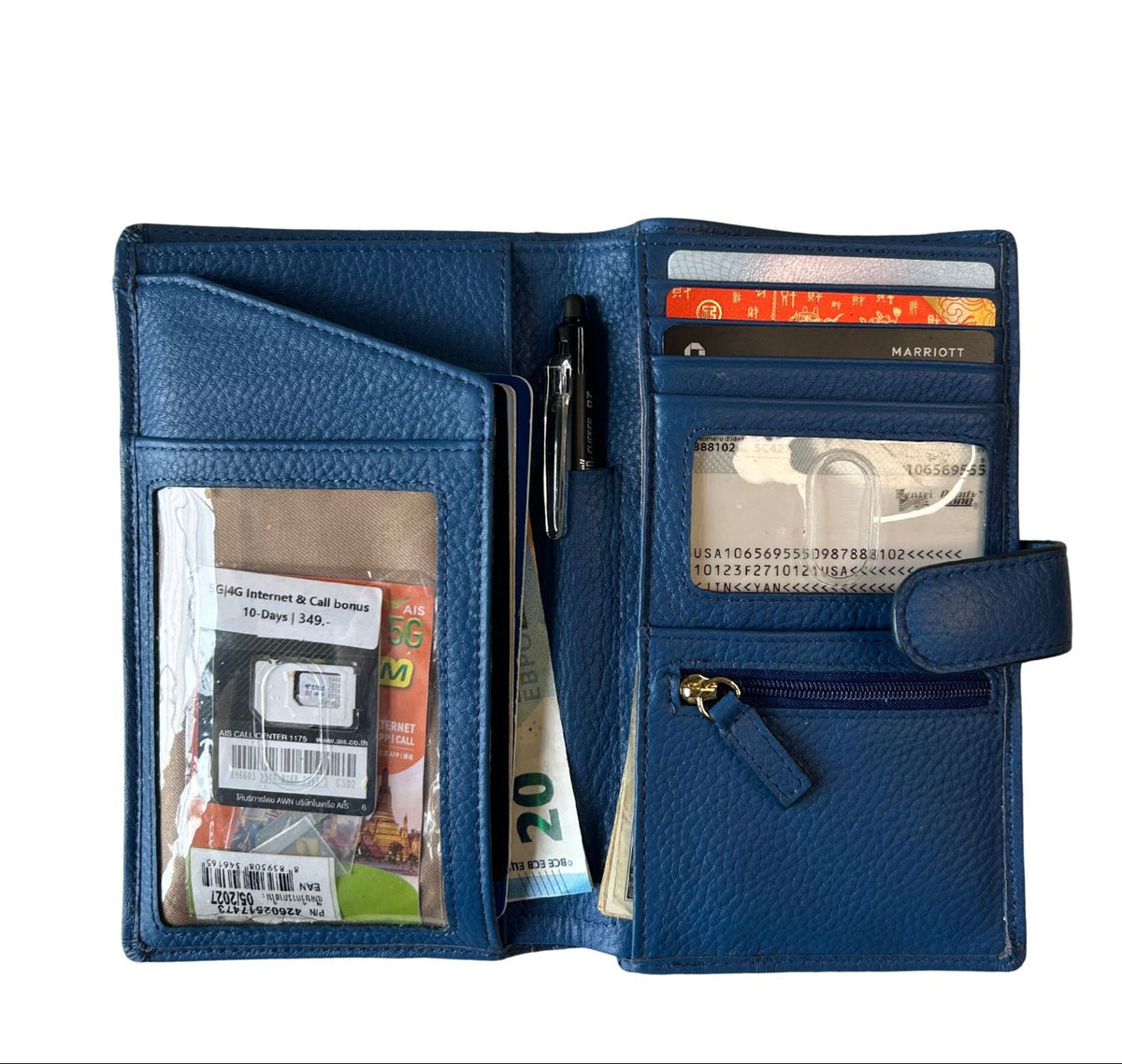 Sophia full-grain leather travel wallet open with passport, cards, ID windows, cash and zip pocket
