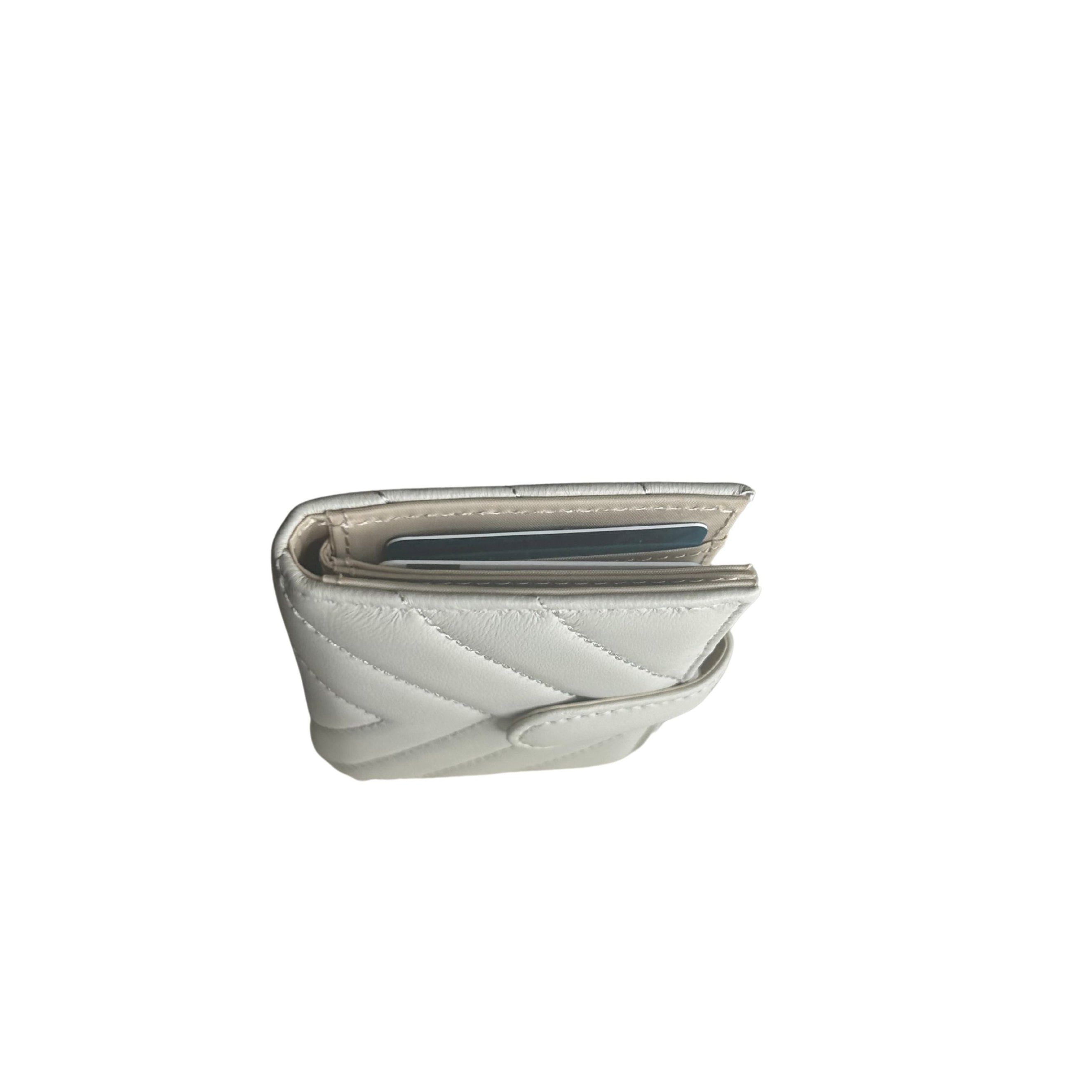 Top view of a white/ivory quilted lambskin leather wallet with card slots.