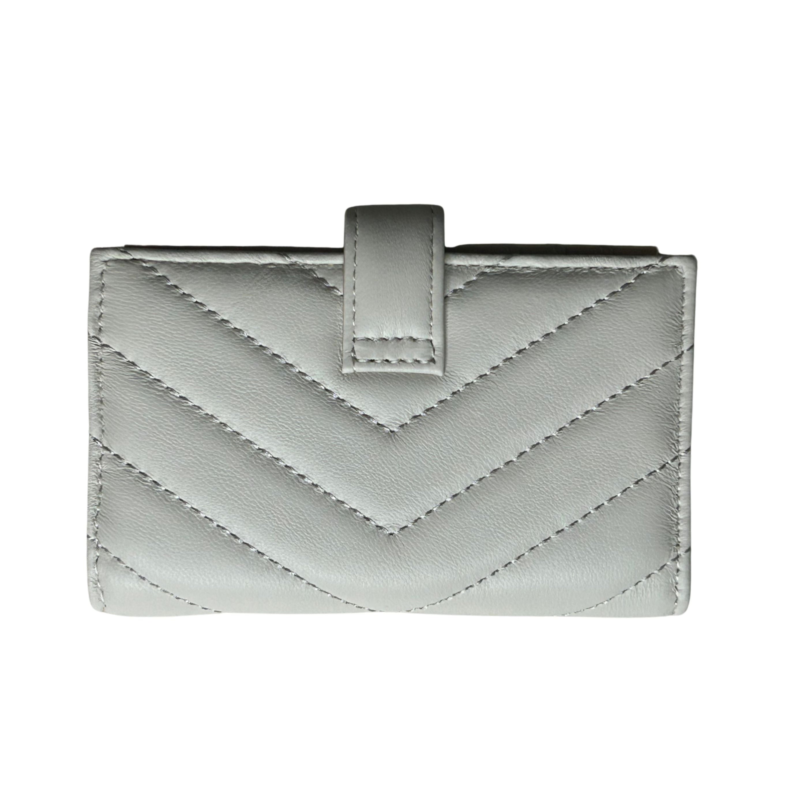 Back view of a white/irvory quilted lambskin leather wallet with a chevron pattern