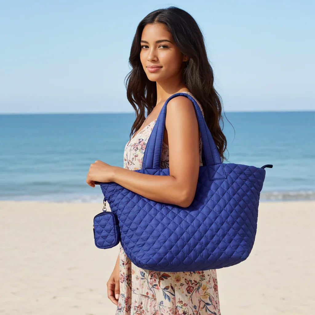Woman carrying blue quilted nylon tote bag at the beach
