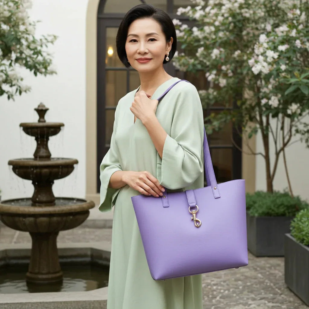 Woman carrying purple pebbled leather tote bag as a shoulder bag
