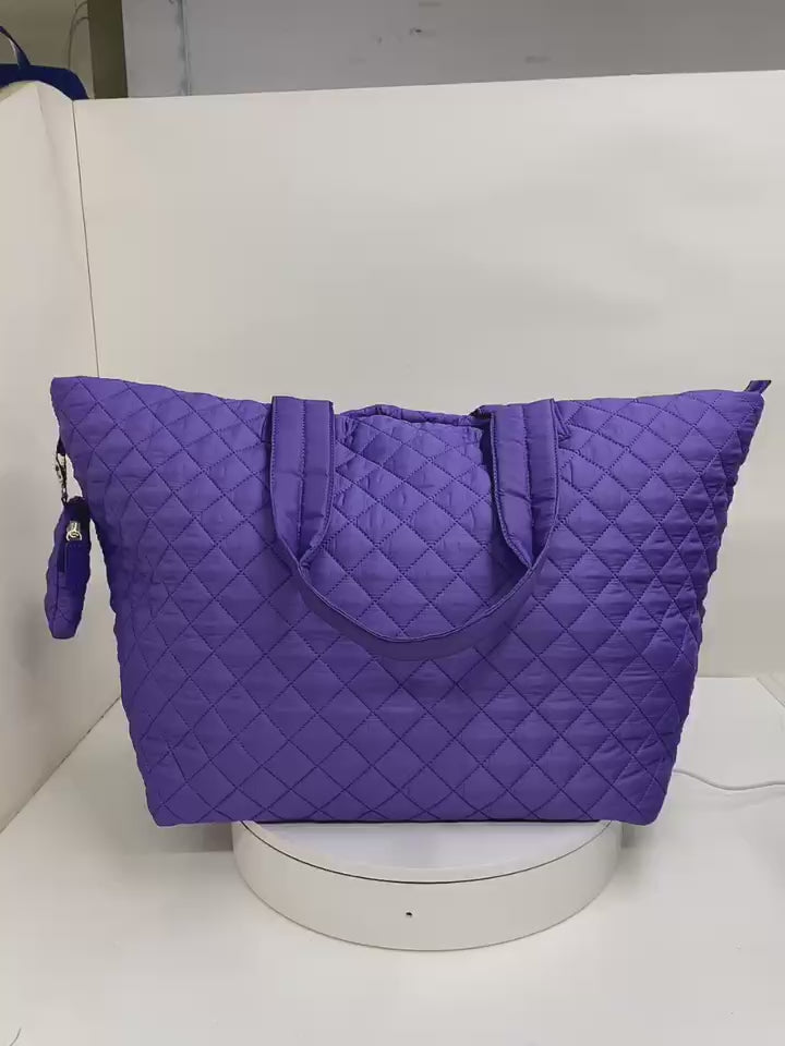 Blue quilted nylon travel tote bag video showing size and shape